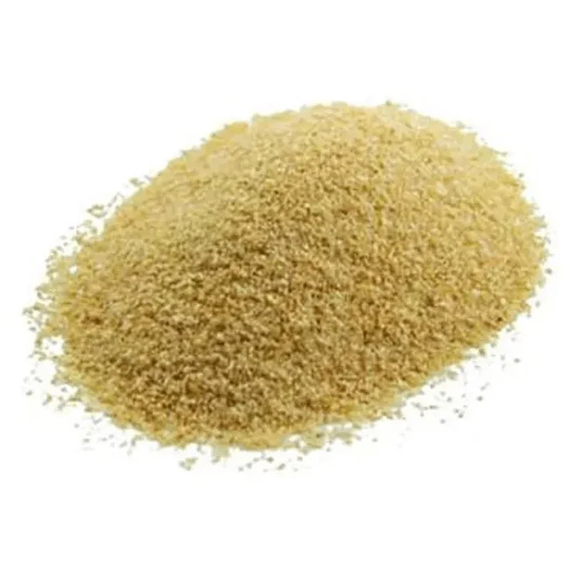 Granulated garlic on a white background ready to be used as a herb in the next meal